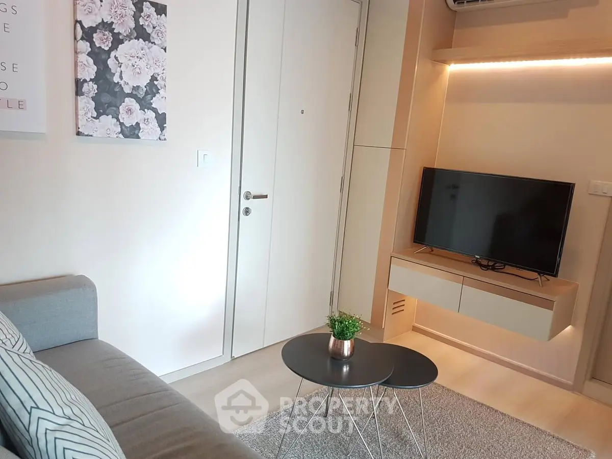 Modern living room with sleek TV unit and cozy seating area