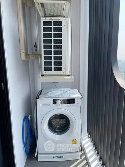 Modern balcony with washing machine and air conditioning unit in high-rise apartment.