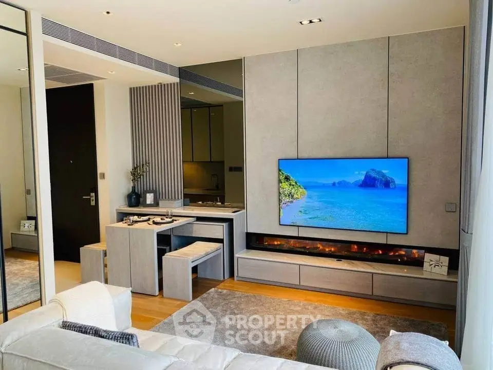 Modern living room with sleek TV setup and cozy seating area, perfect for relaxation and entertainment.