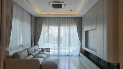 Modern living room with sleek design and large windows for natural light.