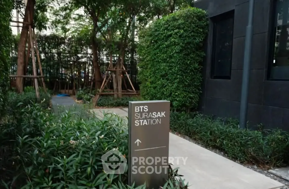 Lush garden pathway near BTS Surasak Station, ideal for urban living.