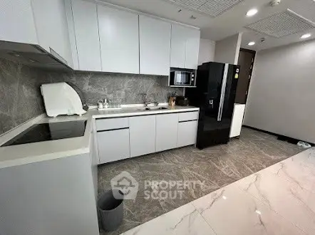 Modern kitchen with sleek cabinetry and marble flooring