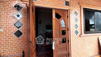 Charming brick exterior with wooden door and window, inviting entrance