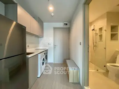 Modern apartment with sleek kitchen and bathroom, featuring stainless steel appliances and stylish design.