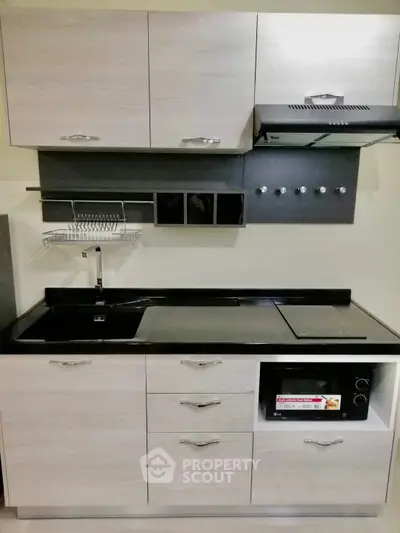 Modern kitchen with sleek cabinetry and built-in appliances, perfect for urban living.