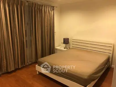 Cozy bedroom with elegant curtains and modern furniture