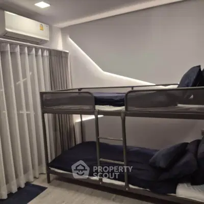 Modern bedroom with bunk beds and stylish lighting, perfect for maximizing space in a contemporary home.