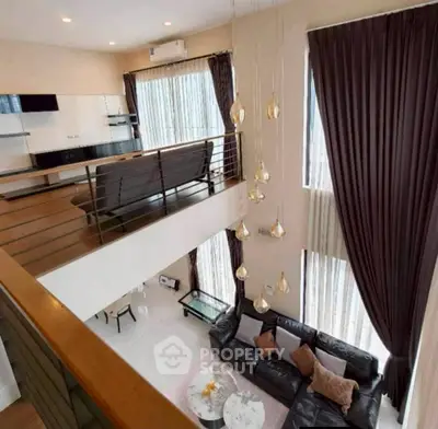 Luxurious two-story living room with modern decor and elegant lighting