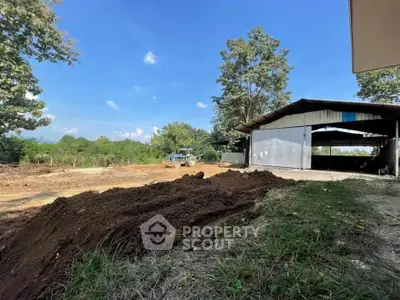 Spacious rural property with open land and large shed, perfect for agricultural use.