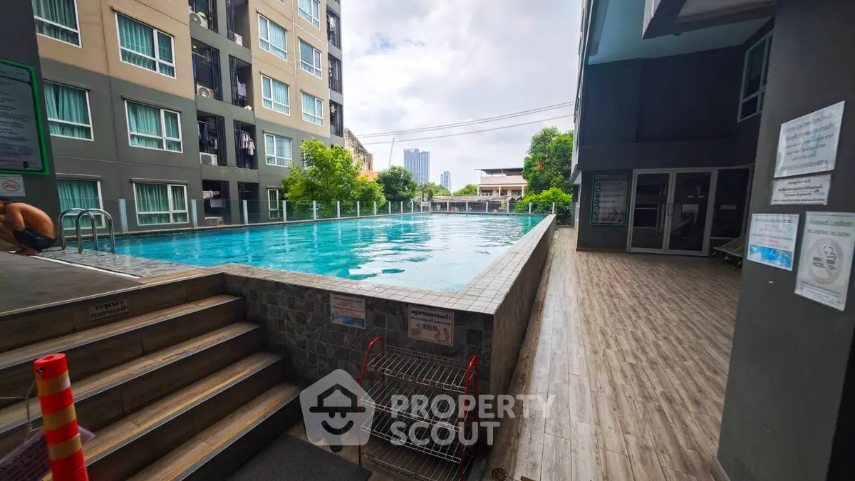 Modern apartment complex with inviting swimming pool and city view