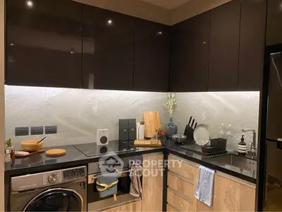Modern kitchen with sleek cabinets, built-in appliances, and stylish backsplash.
