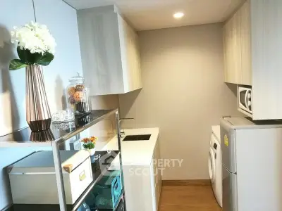 Modern compact kitchen with washing machine and sleek cabinetry