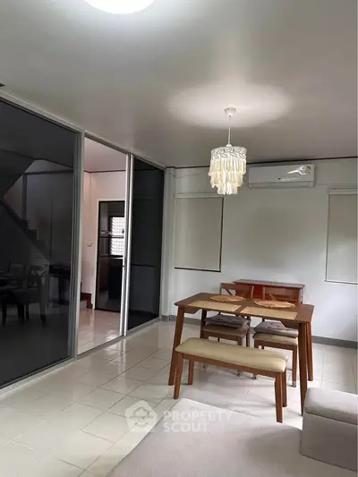 Spacious dining area with modern furniture and air conditioning in a stylish home interior.