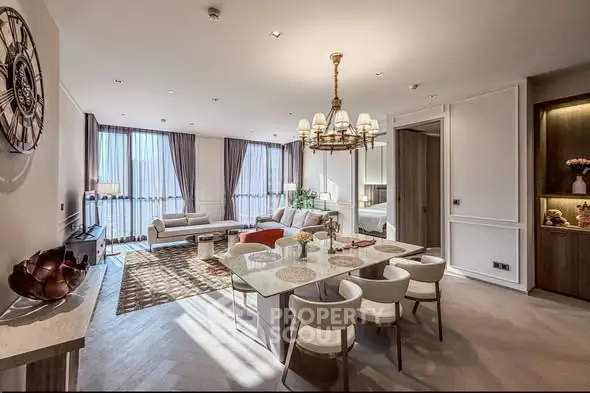 Luxurious open-plan living and dining area with elegant decor and natural light.