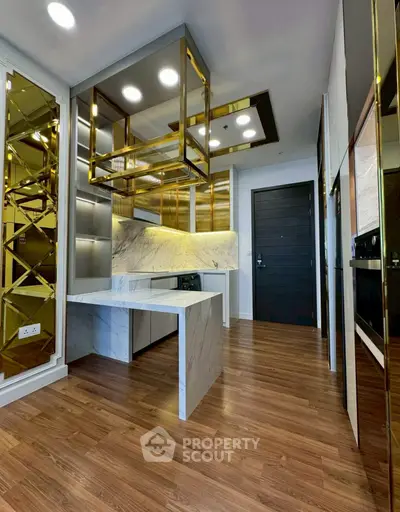 Luxurious modern kitchen with marble countertops and gold accents