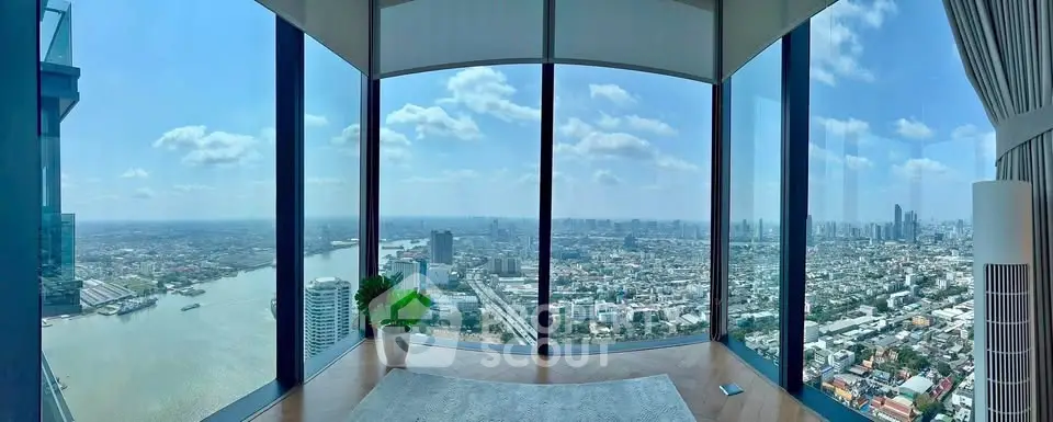 Stunning corner unit with panoramic city and river views from floor-to-ceiling windows.