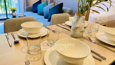 Modern dining setup in stylish living room with cozy seating and elegant decor.
