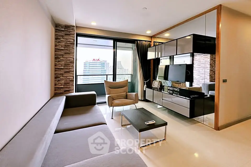 Modern living room with sleek furniture and large windows offering city views.