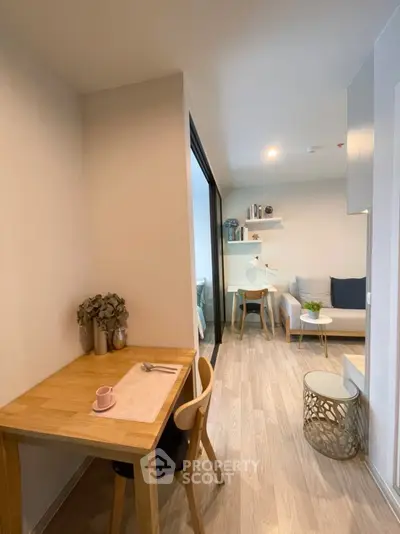 Modern apartment interior with cozy living room and dining area, featuring stylish decor and natural light.
