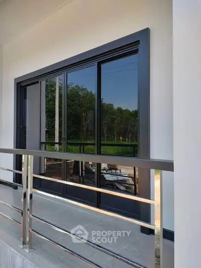 Modern balcony with sleek glass doors and scenic view