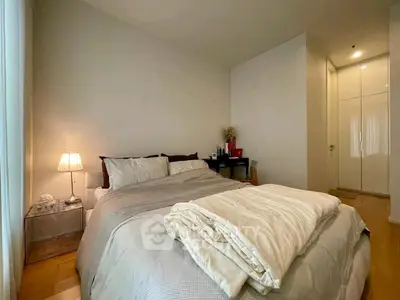 Cozy bedroom with modern decor and soft lighting, perfect for relaxation.