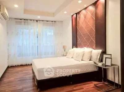 Spacious bedroom with elegant decor and natural light