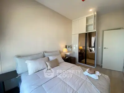 Cozy modern bedroom with elegant decor and ample natural light