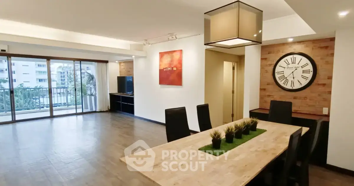 Spacious modern living room with dining area and large windows offering a great view.