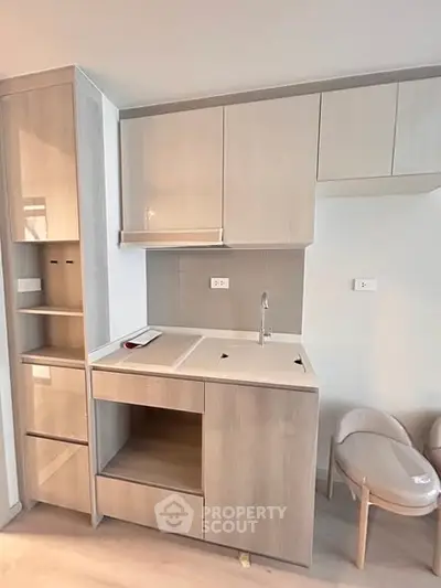 Modern kitchen with sleek cabinetry and integrated appliances in a compact layout.