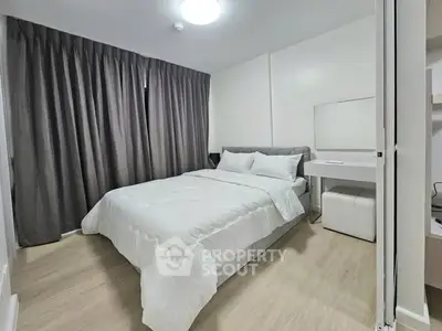 Modern bedroom with cozy bed and elegant decor in a stylish apartment.