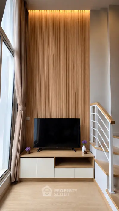 Modern living room with stylish wood paneling and sleek TV setup