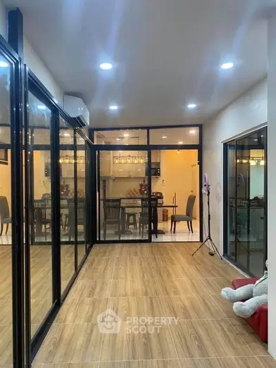 Spacious modern living area with glass doors and elegant dining space