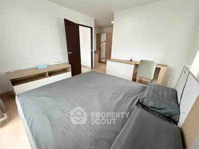 Spacious bedroom with modern furniture and neutral decor