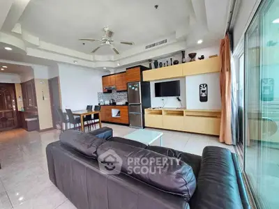 Spacious modern living room with open kitchen and stylish decor in a luxury apartment.