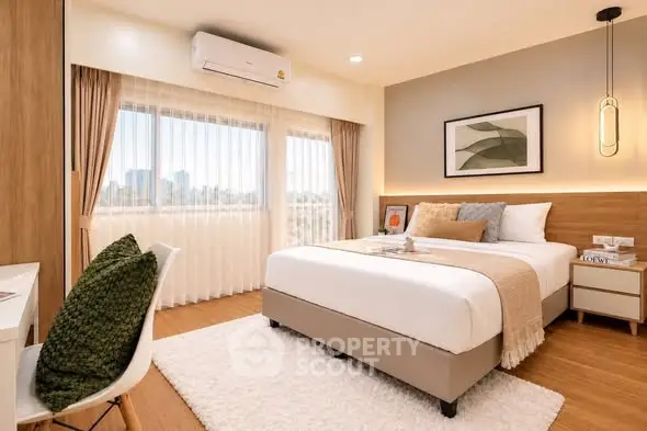 Modern bedroom with large windows and stylish decor in a cozy apartment.