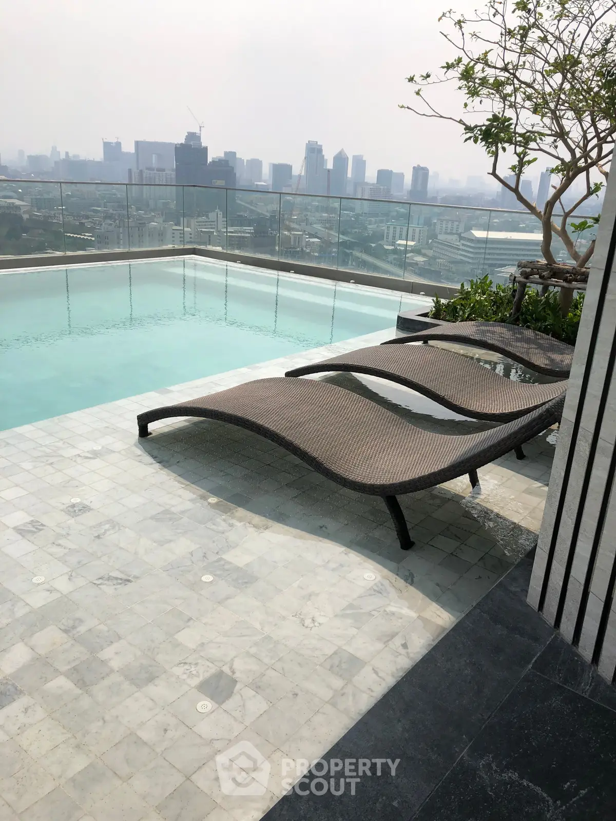 Luxurious rooftop pool with stunning city skyline view, perfect for relaxation and leisure.
