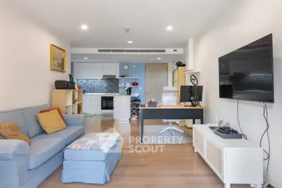 Modern living room with open kitchen and stylish decor in a cozy apartment.