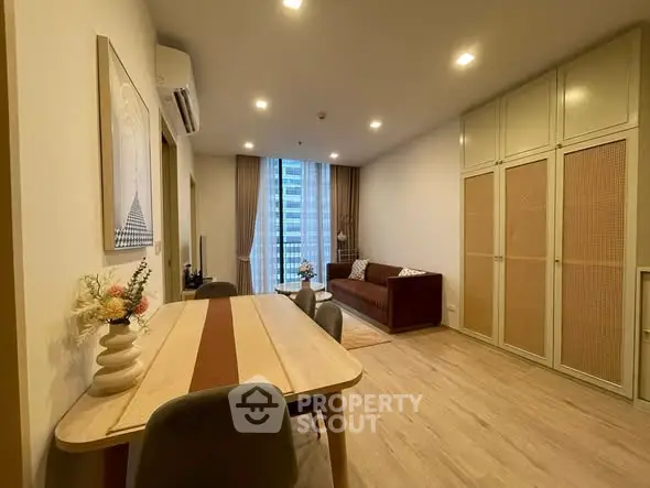 Spacious modern living room with elegant dining area and large windows in a high-rise apartment.