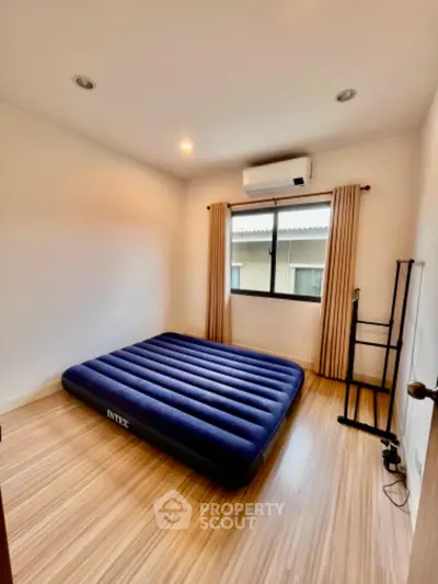 Minimalist bedroom with air mattress and natural light