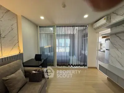 Modern living room with stylish decor and open kitchen layout in a contemporary apartment.