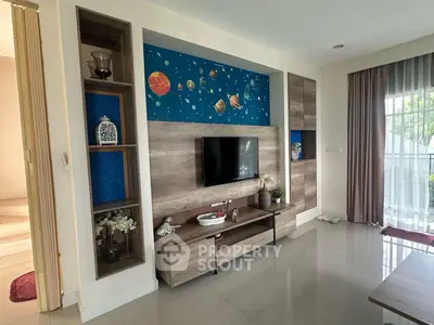 Modern living room with stylish entertainment center and planet-themed decor