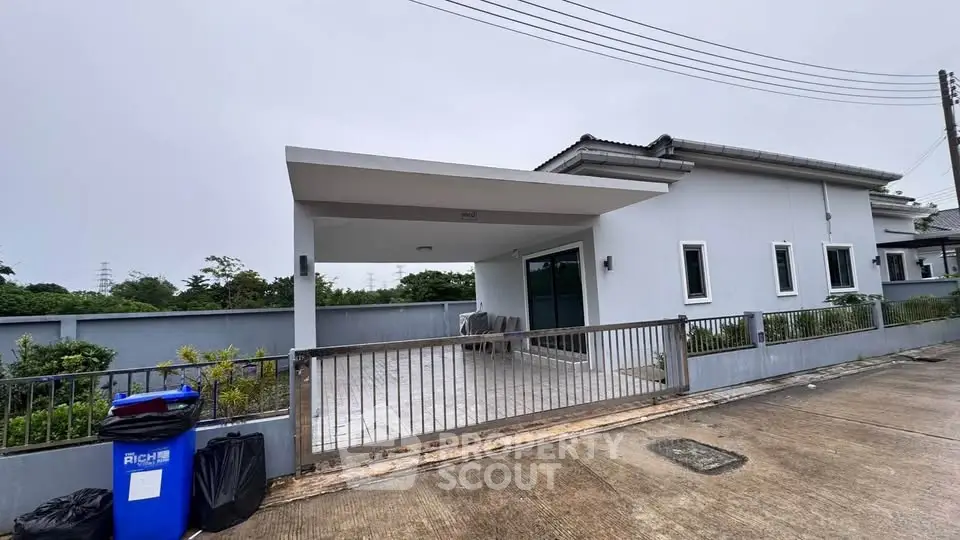 Modern single-story house with covered carport and sleek exterior design.