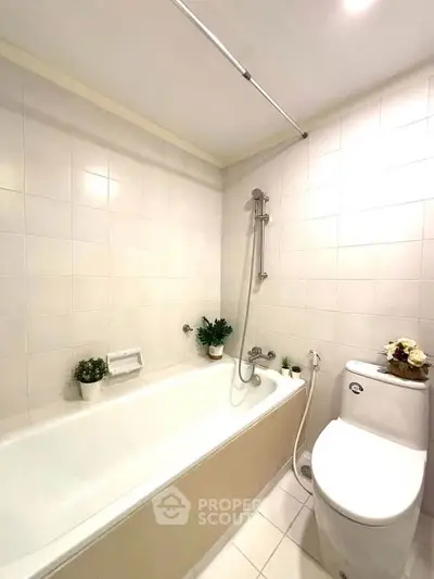 Modern bathroom with sleek bathtub and elegant fixtures, perfect for relaxation.