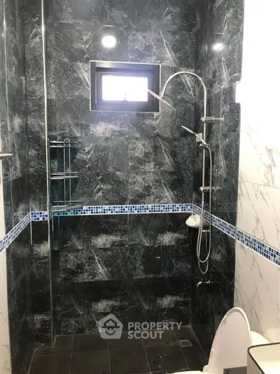 Luxurious marble bathroom with modern shower and elegant tile accents