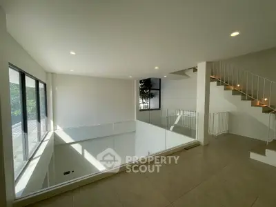 Spacious modern interior with open layout and large windows offering natural light.