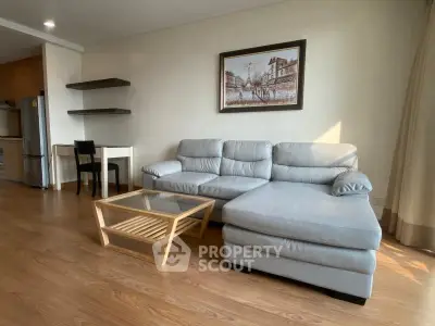 Spacious living room with modern sofa and wooden flooring