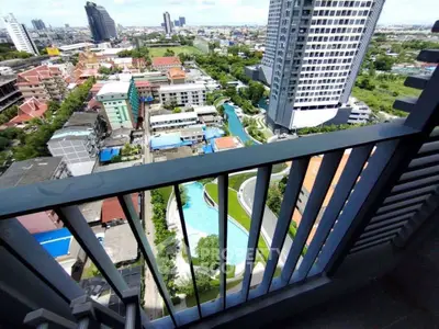Stunning high-rise balcony view overlooking cityscape and pool area, perfect for urban living enthusiasts.