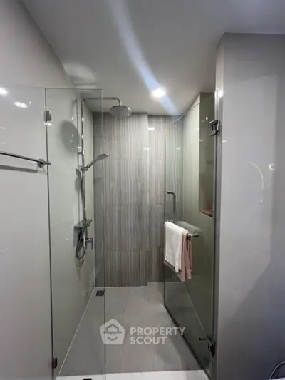 Modern bathroom with glass shower enclosure and sleek tile design