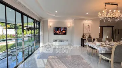 Luxurious living room with elegant dining area, marble floors, and pool view through large glass doors.