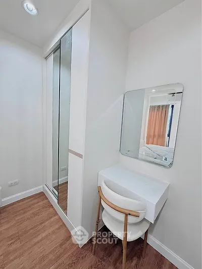 Modern bedroom with sleek vanity and mirrored closet doors